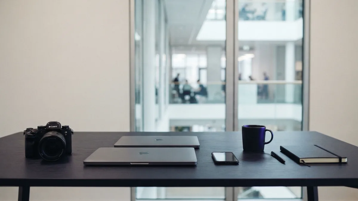 A workspace for app development planning Minimal office desk with devices representing app development choices and product planning