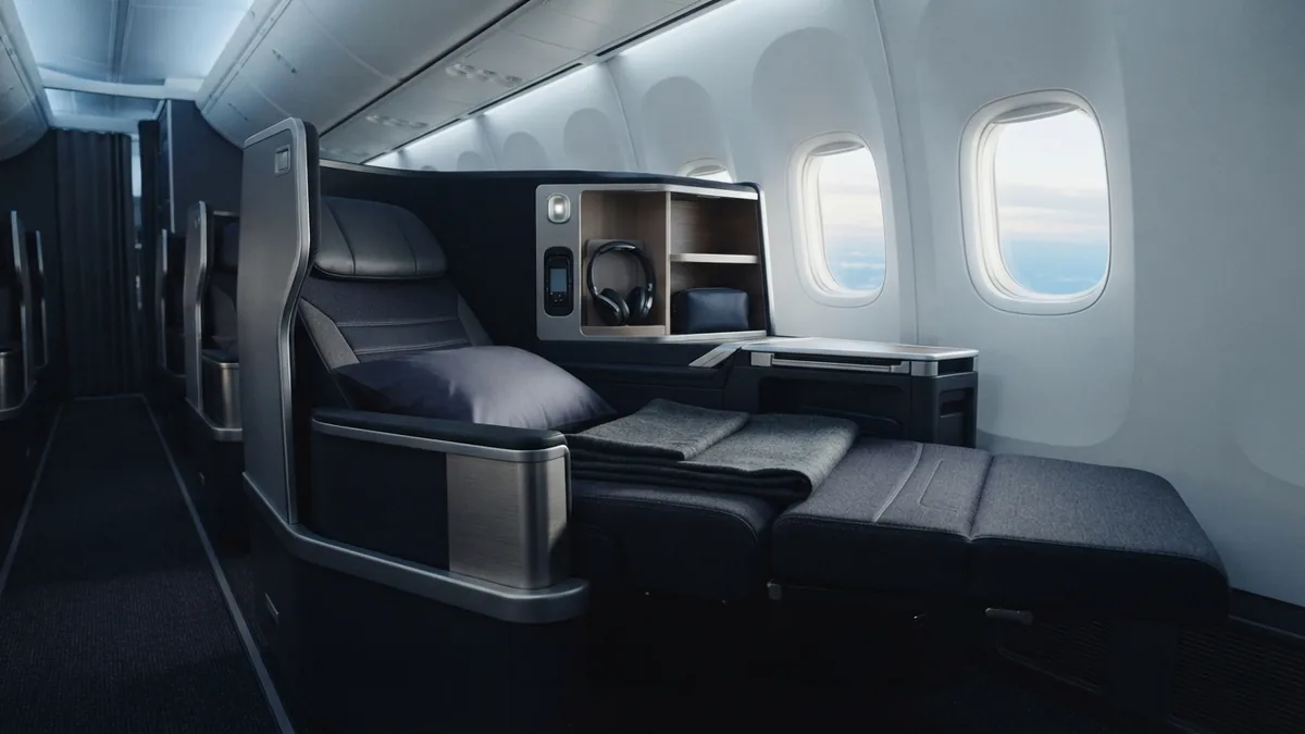 Modern lie-flat aircraft seat showing generous space and clean cabin design