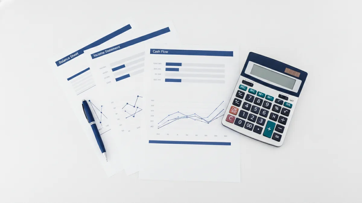 Business finance documents and calculator showing lender risk review