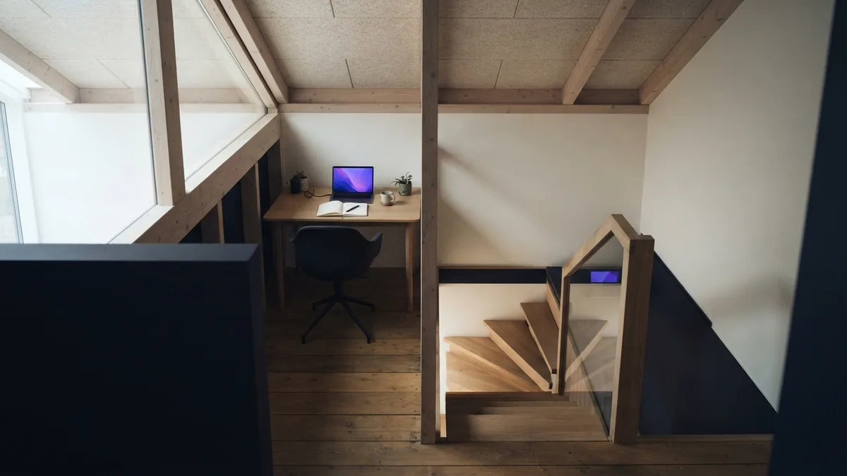 Loft space showing insulation, timber details, and a safe stair opening